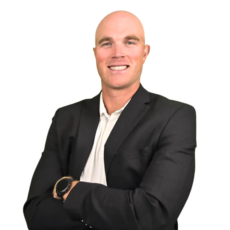 Headshot of Michael Groselle in a dark blazer, arms crossed.